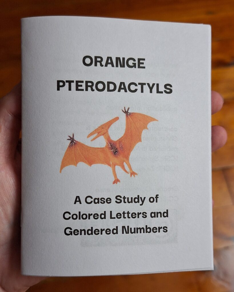 cover of the Orange Pterodactyl zine, with the image of a plastic toy pterodactyl.